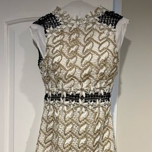 Cutest mini black white dress with gold accents.  Back is so cute.